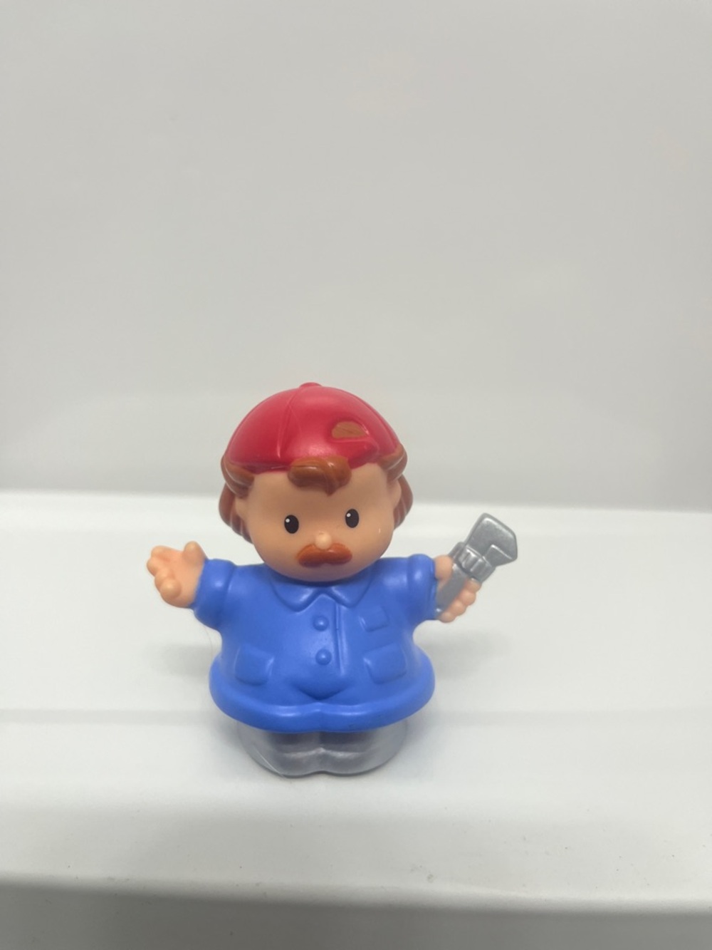 Fisher-Price little people Blue-Shirted Worker Figure with Red Cap mechanic